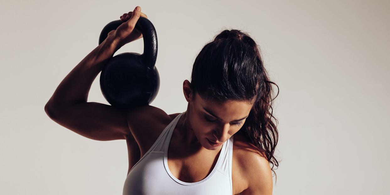 Determined young woman doing gym workout