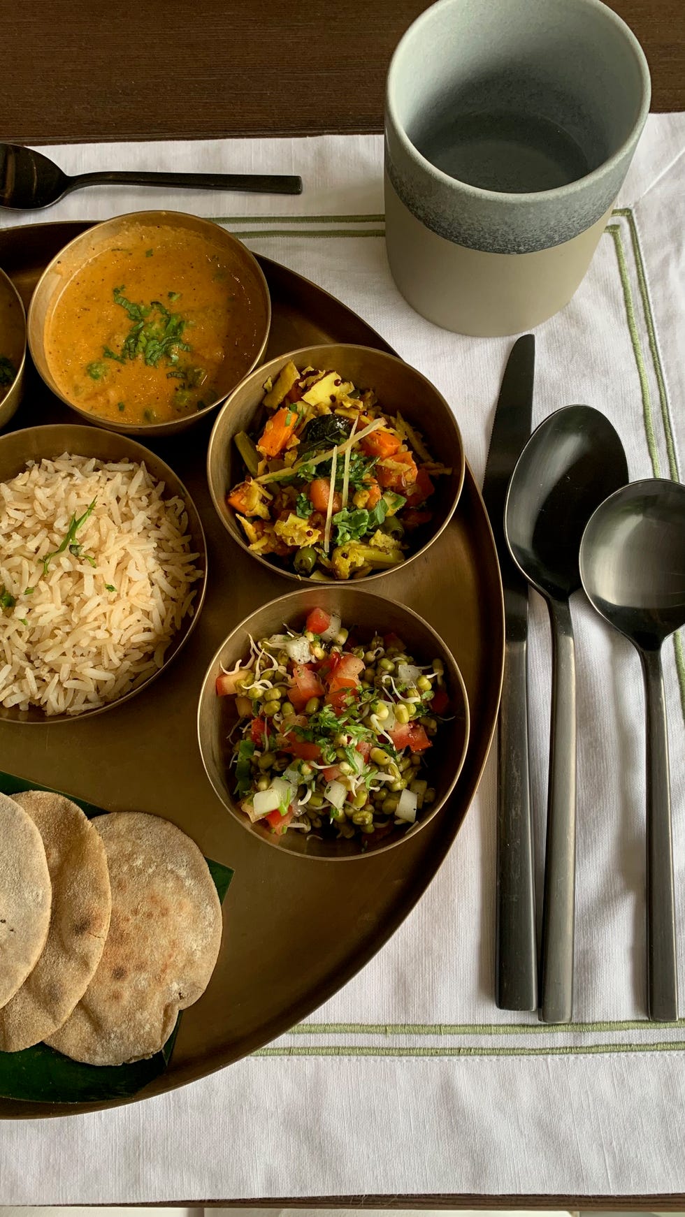 traditional indian meal served on a tray with various dishes