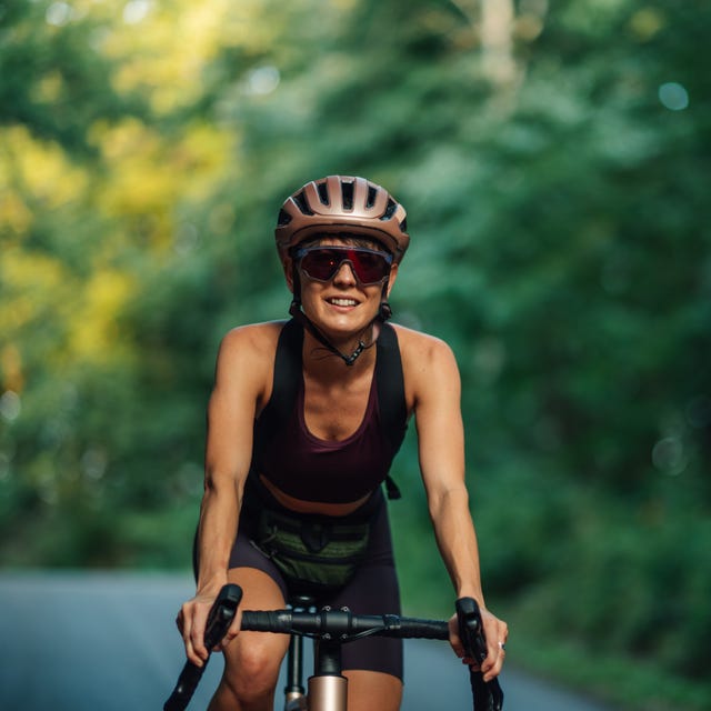 Female cyclist enjoying a ride on a forest road