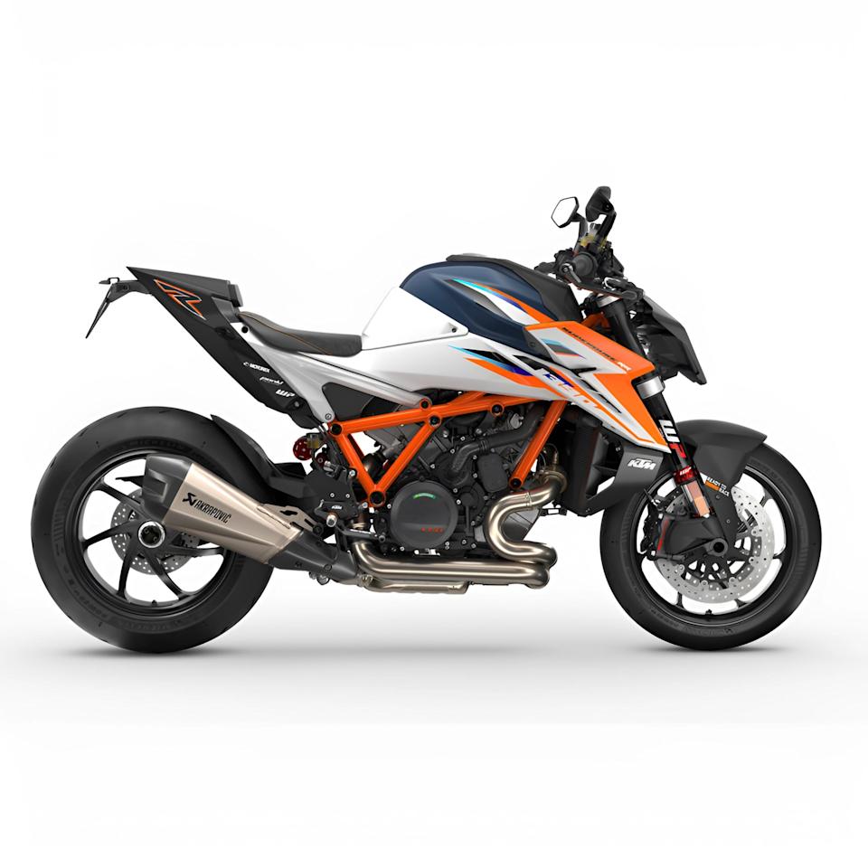 Sporty KTM motorcycle with orange frame, white and blue body panels, and Akrapovic exhaust on a white background.