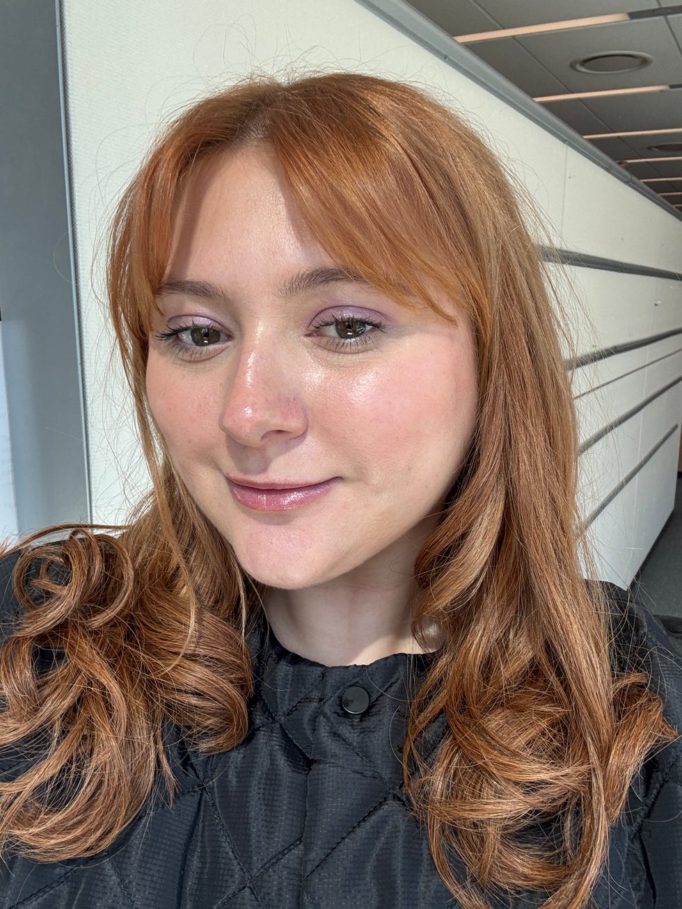 Person with long, wavy reddish-brown hair and a black quilted top. Person with long, wavy reddish-brown hair and a black quilted top.