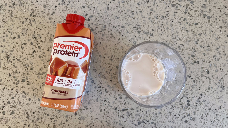 Caramel flavored bottle and a glass cup