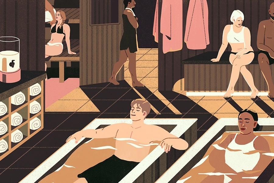 A sauna room with several people relaxing. Two individuals are soaking in rectangular hot tubs filled with water, one man and one woman. A woman in a black dress is walking through a doorway. Another woman in a black bikini sits on a wooden bench inside the sauna, while a woman with short white hair in a white top and black bottoms sits on a bench outside the sauna. Towels are neatly rolled and stored on shelves, and pink towels hang on hooks near the doorway. The floor is tiled with a geometric pattern.