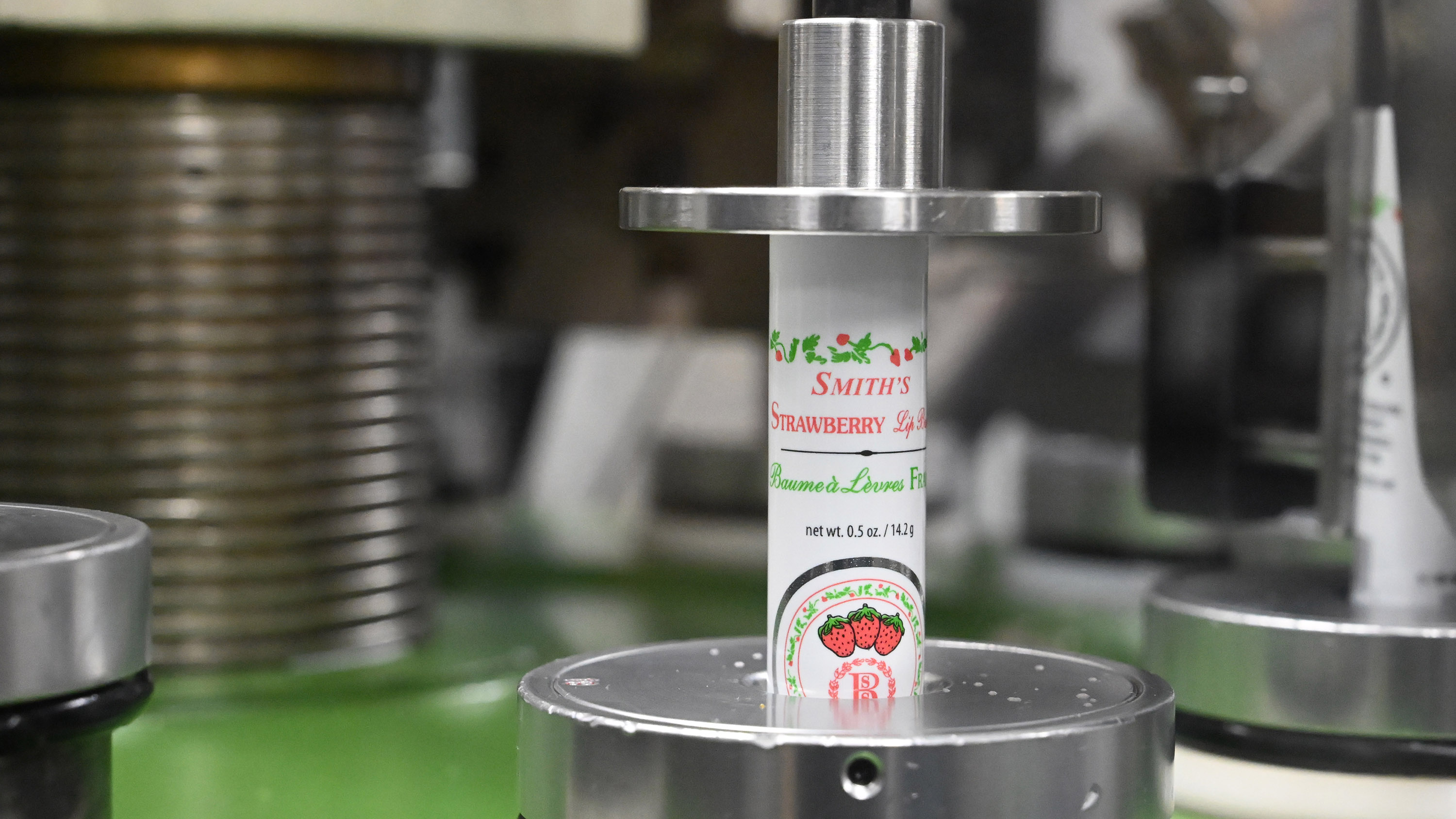 Tubes of Smith's Strawberry Lip Balm are aligned for filling...