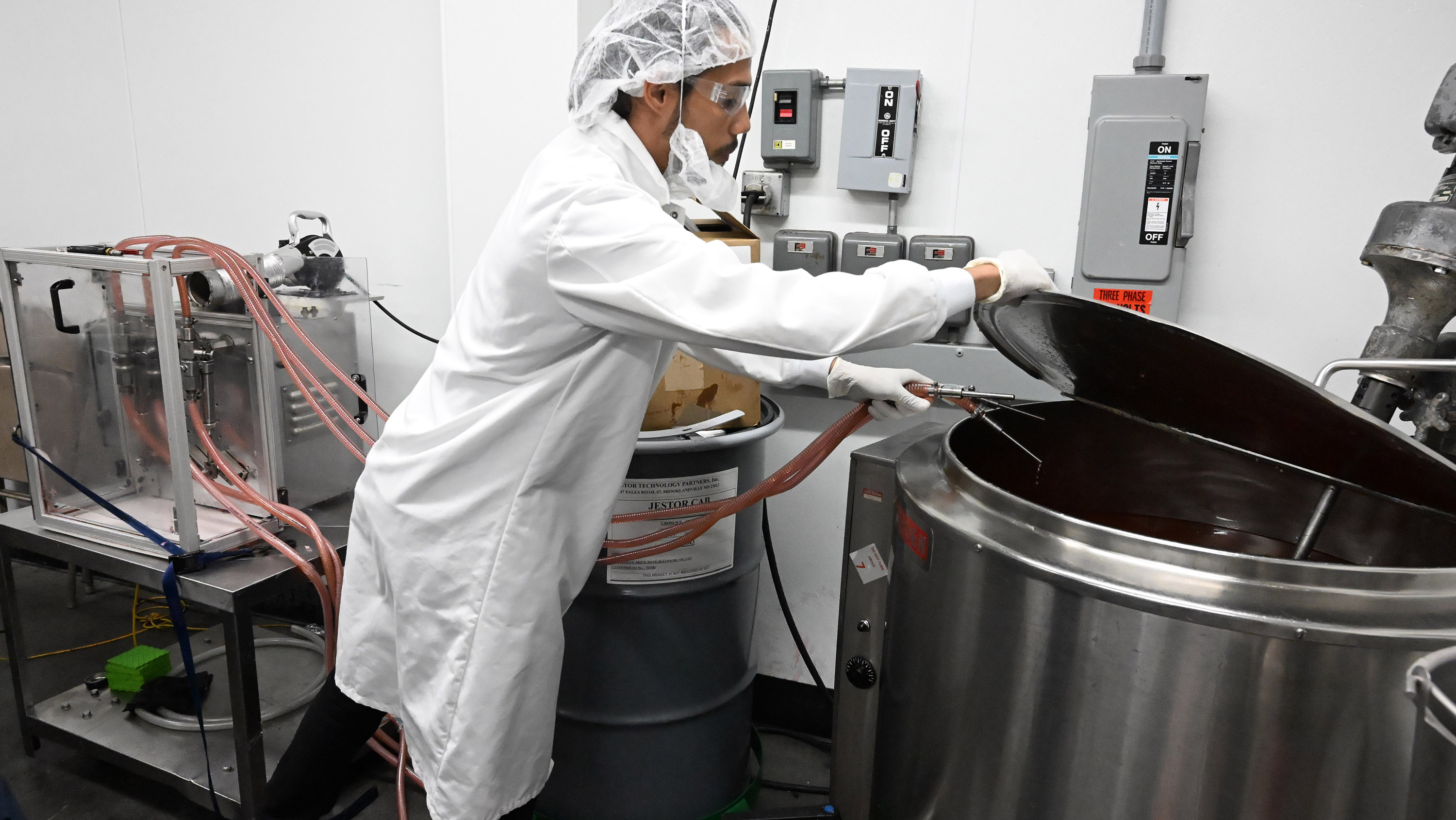 Eli Morales runs tubes to a tank of Smith's Strawberry...