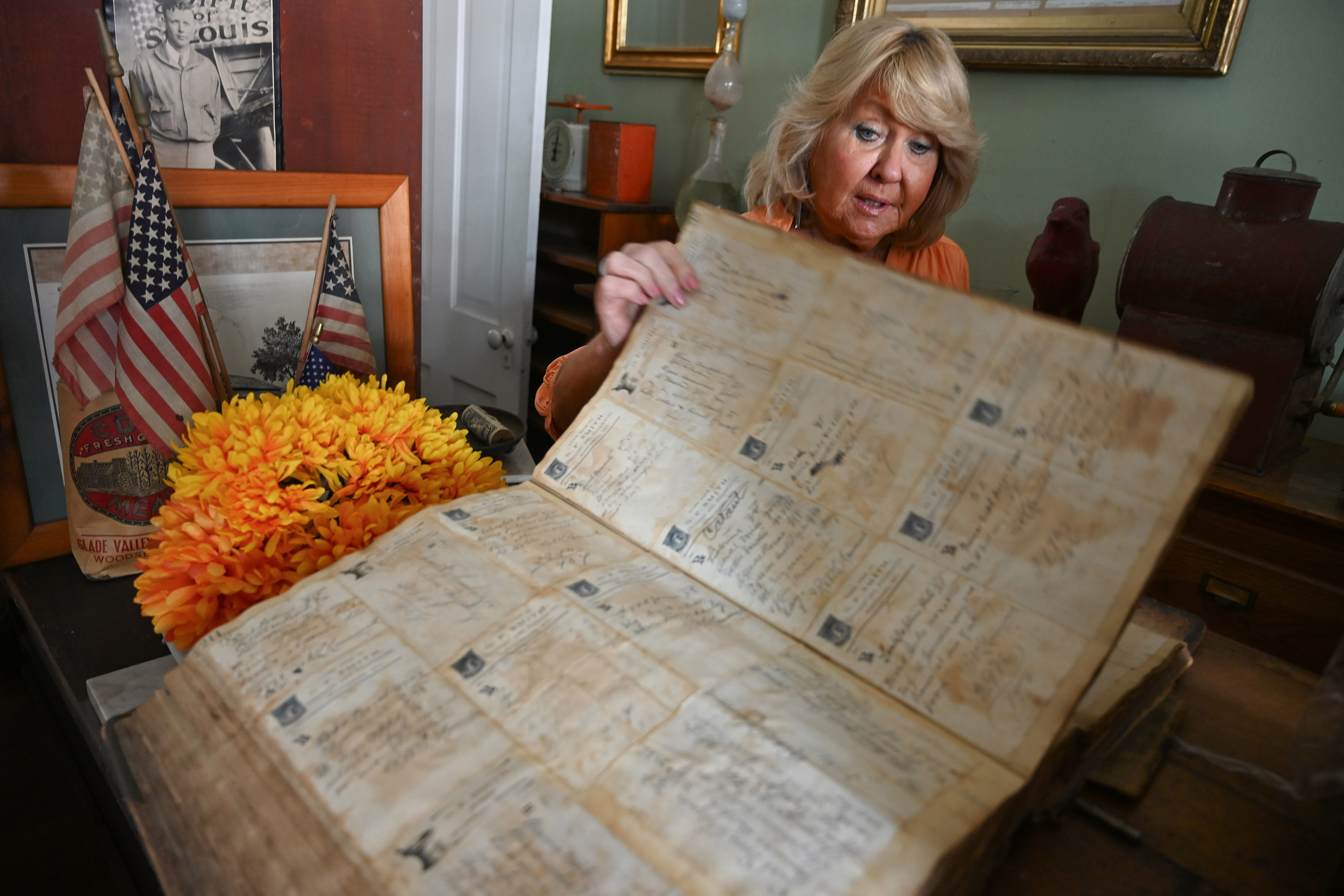 Linda Pruitt-Michielli leafs through a book of handwritten prescriptions at...