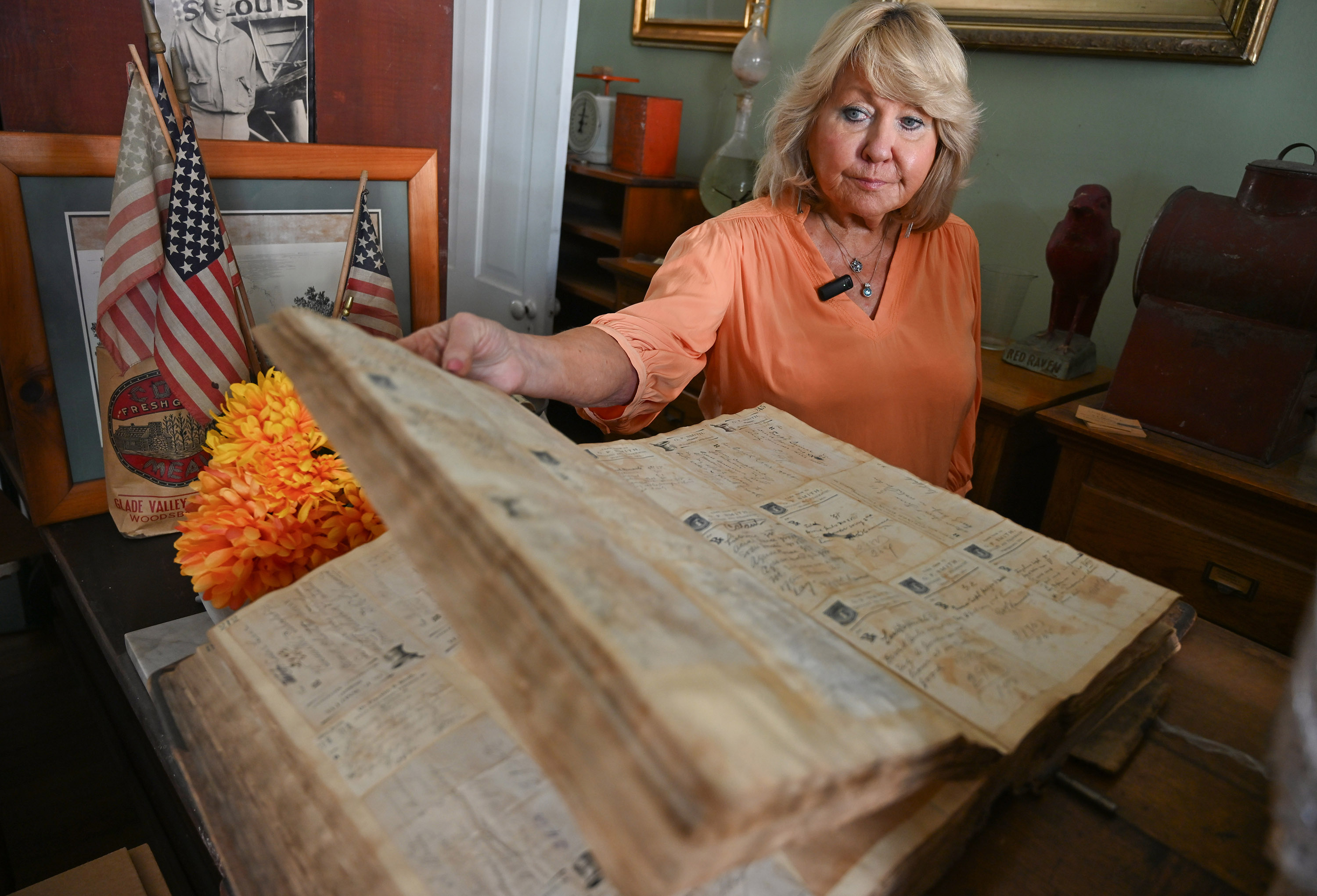 Linda Pruitt-Michielli leafs through a book of handwritten prescriptions at...