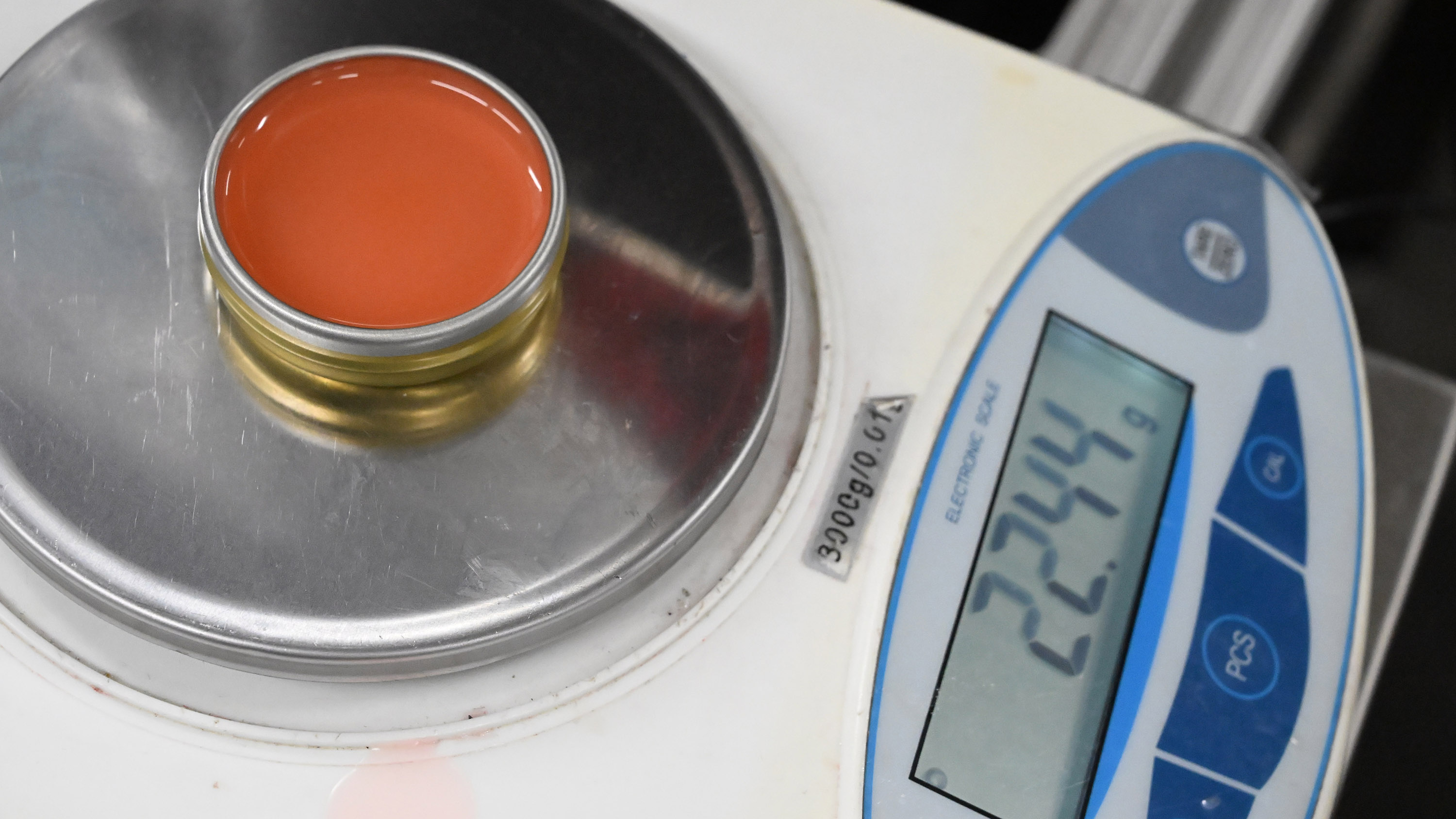 A tin of Smith's Strawberry Lip Balm is measured for...