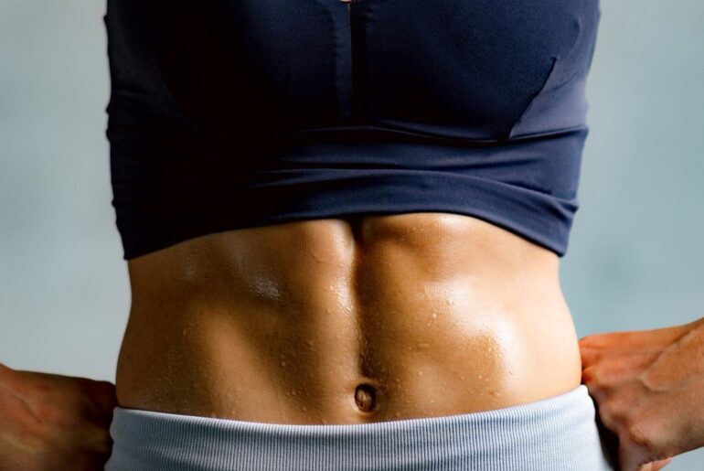 a photo of a woman with strong abs