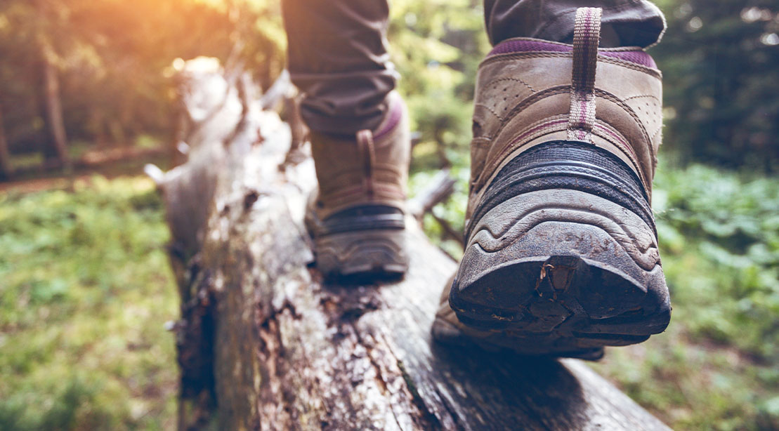 Hiker wearing rough and rugged hiking boots