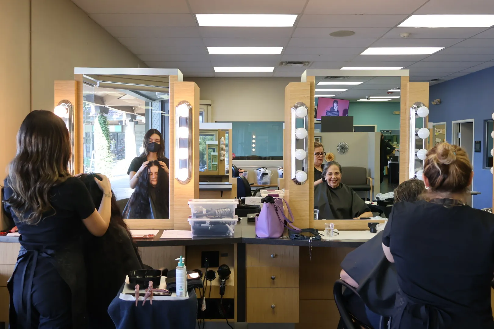 Left to right, Isabelle Magdalena does Molly Myers's hair next...