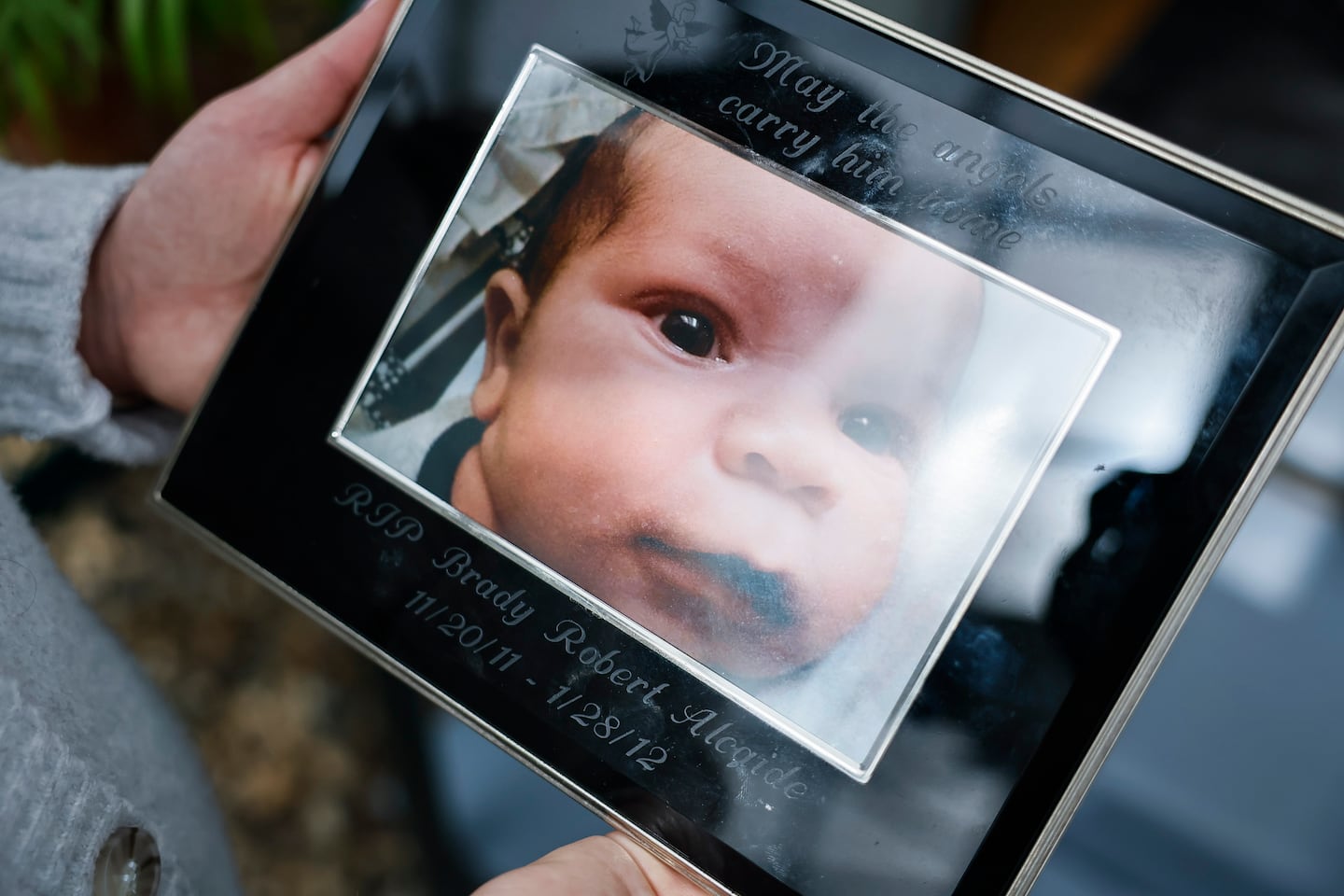 Alcaide held a photo of her infant son.