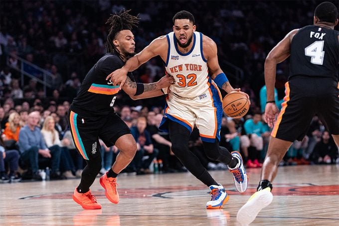Karl-Anthony Towns of the New York Knicks is defended by Stephon Castle of the San Antonio Spurs during the first quarter of the game at Madison Square Garden