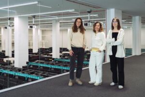 BSC researchers Aida Ripoll-Cladelles (left), Marta Melé (center) and Maria Sopena-Rios (right) in front of MareNostrum 5 supercomputer. [Mario Ejarque / BSC-CNS]