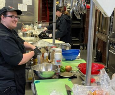 Team Nourish Kids of RSU 22 competitor and Maine DOE 2026 Farm-to-School Cook-Off Champion Hannah Liberty works in the kitchen Wednesday. (Spectrum News/David Ledford)
