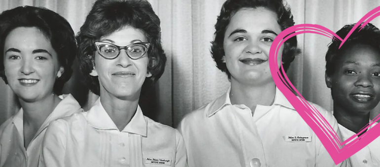 Four women looking proudly at the camera in nursing uniforms