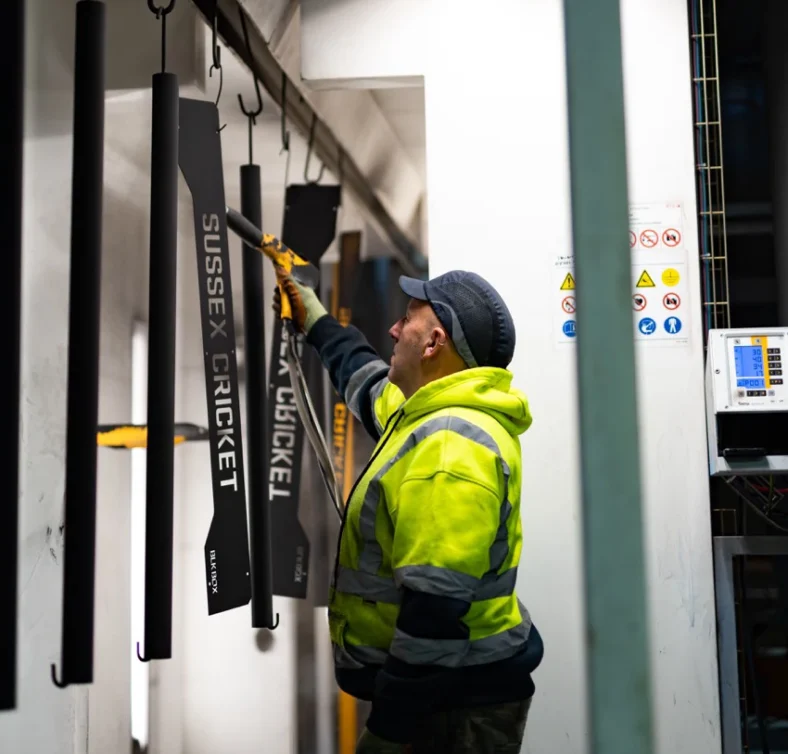 man welds custom equipment in Blk Box's factory in Belfast