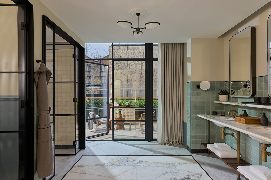 Bathrooms feature white marble and glossy blue tiles