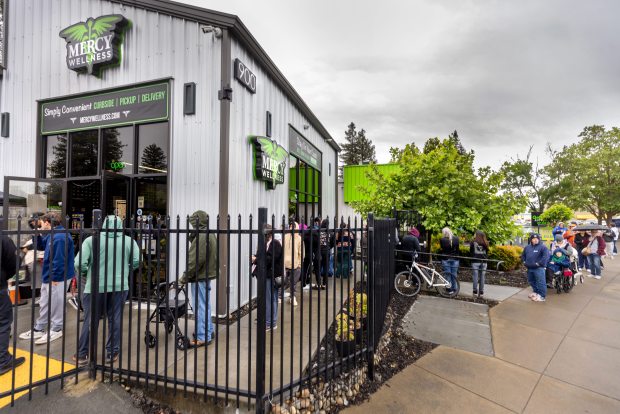 A line of people seeking 420 deals stretched around the block from the Mercy Wellness Dispensary on the unofficial holiday for cannabis users Monday, April 20, 2026 in Santa Rosa. (John Burgess/The Press Democrat)