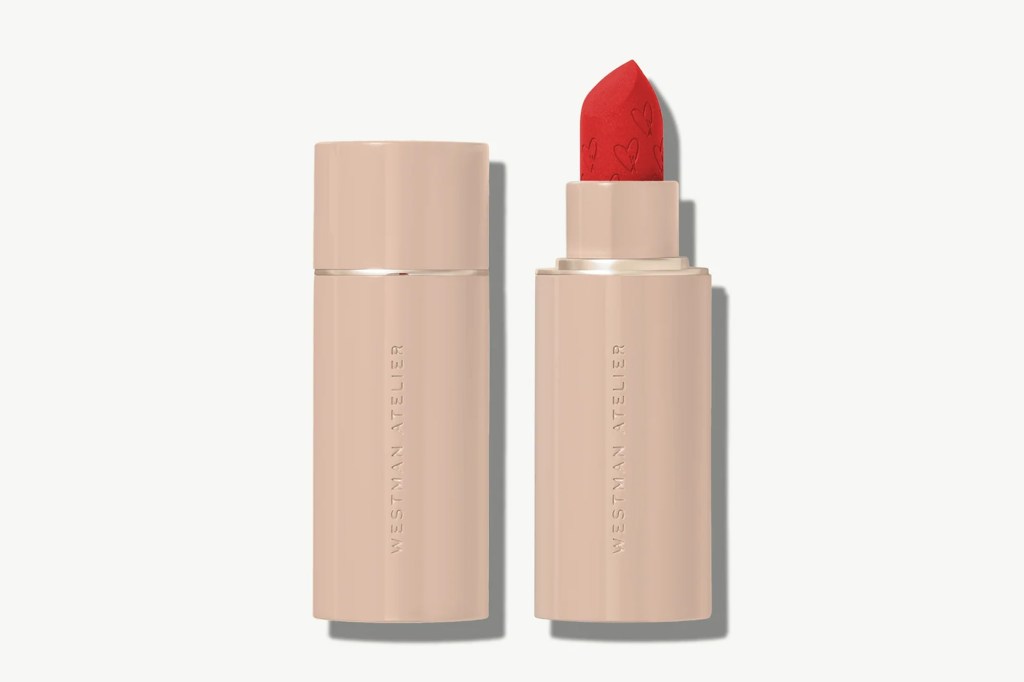 Westman Atelier red lipstick tube with a heart-embossed lipstick and its cap.