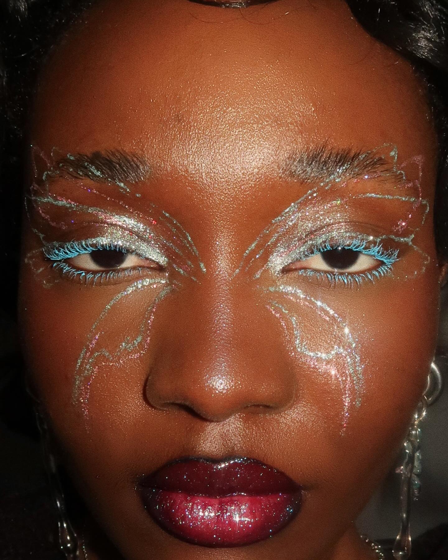 An image of makeup artist Lynda Florae with butterfly makeup.