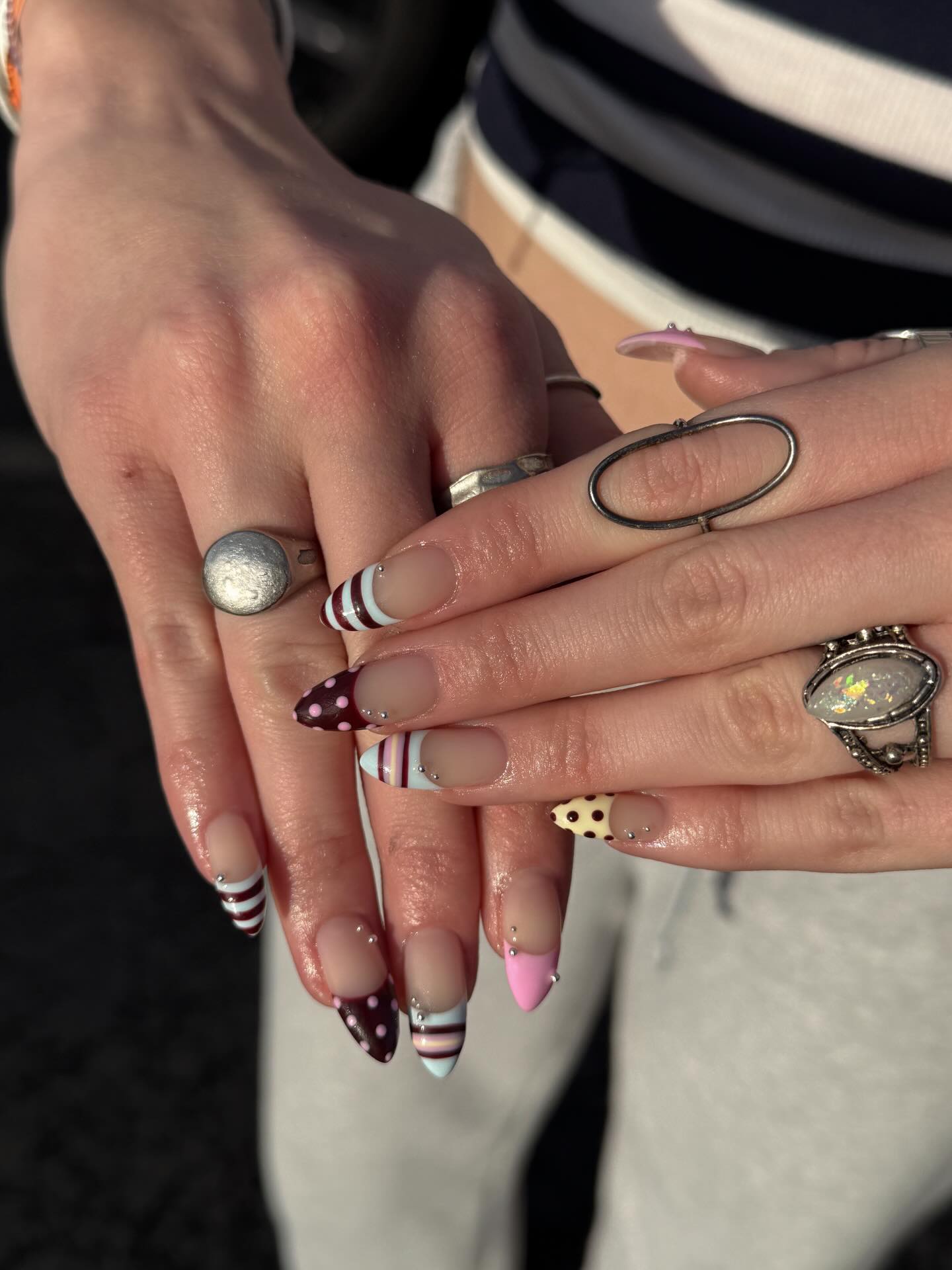 Mismatched nails with metal studs.