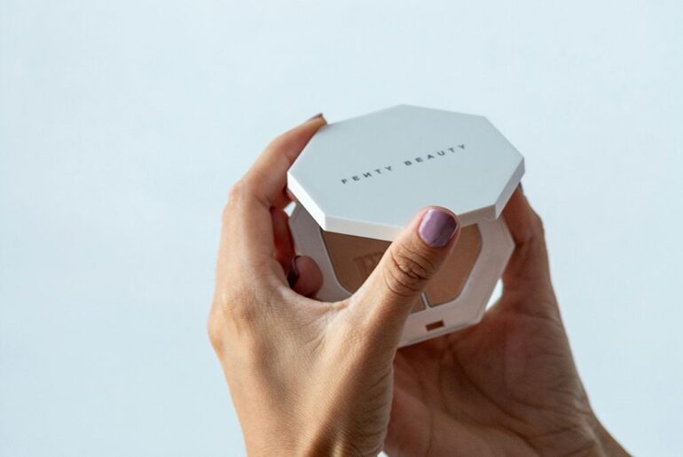woman holding fenty beauty compact