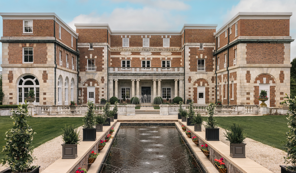 Historic mansion with a formal garden and water feature.