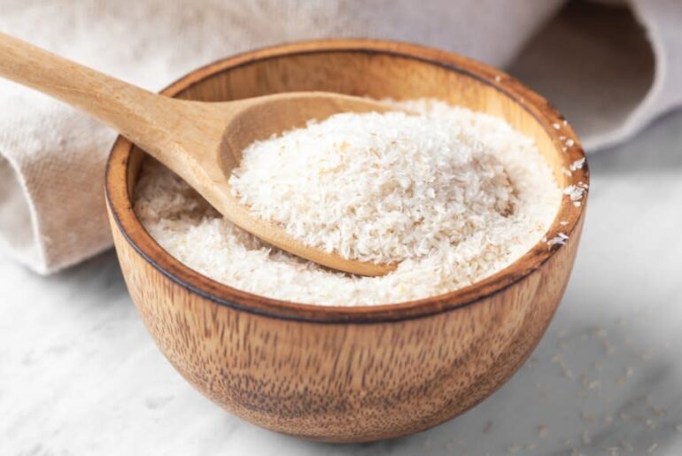 close-up of psyllium husk, the best fiber supplement to lower cholesterol, in a wooden bowl