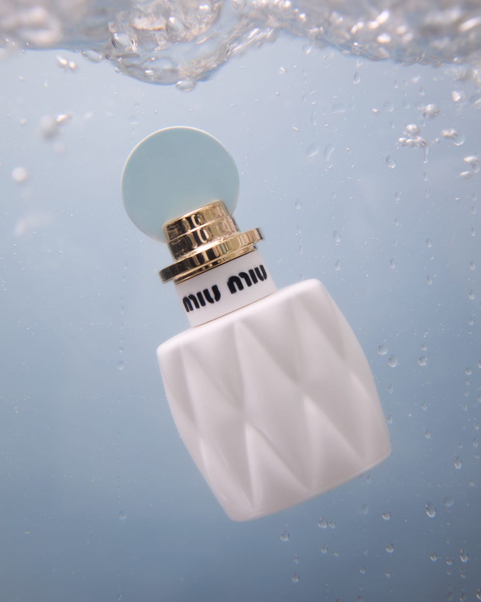 Fragrance bottle submerged in water.