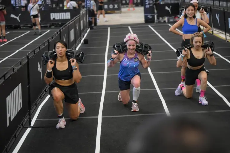 Carolyn Soemarjono (centre), a cancer survivor in her 60s, doing sandbag lunges during the Hyrox Singapore race held at the National Stadium on April 5, 2026.