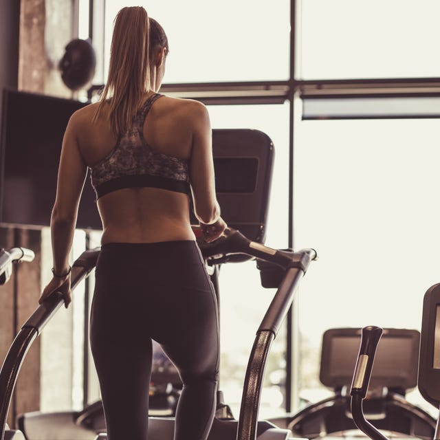 Full length of fit young female working out on stair climbing machine