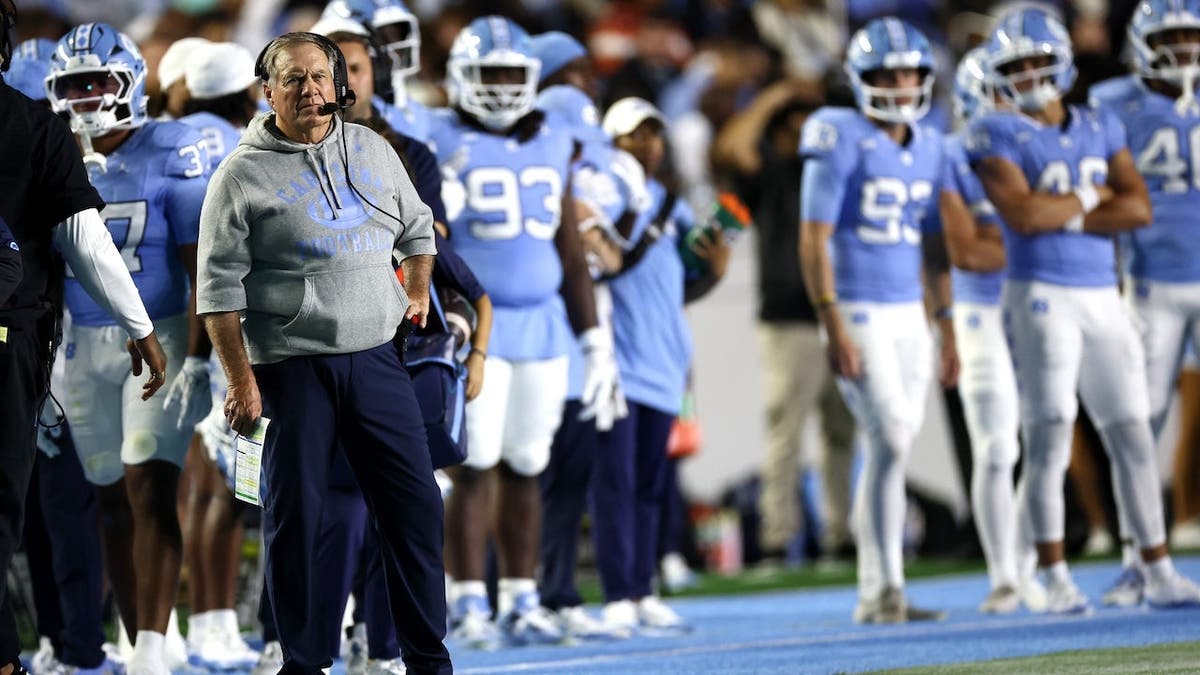 Head coach Bill Belichick standing on the sideline at Kenan Stadium in Chapel Hill
