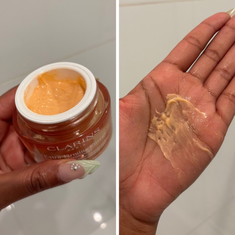 The Clarins Energy Moisturizer with the lid off, and spread across the palm of a hand.