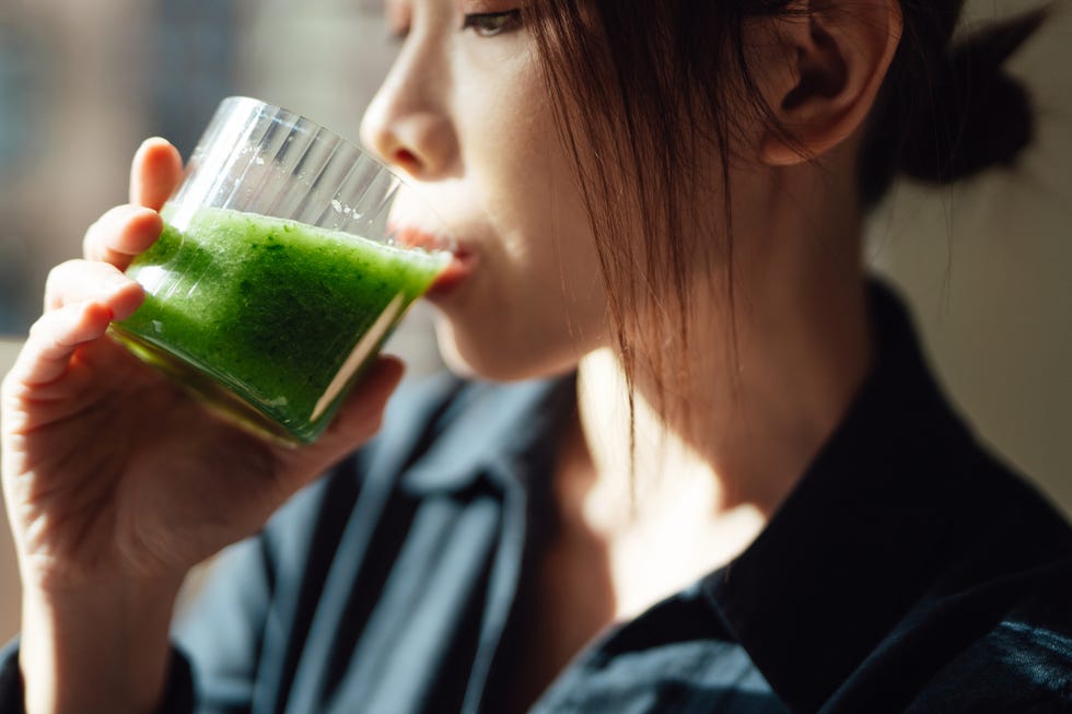 close up of young asian woman drinking healthy detox for a healthy living