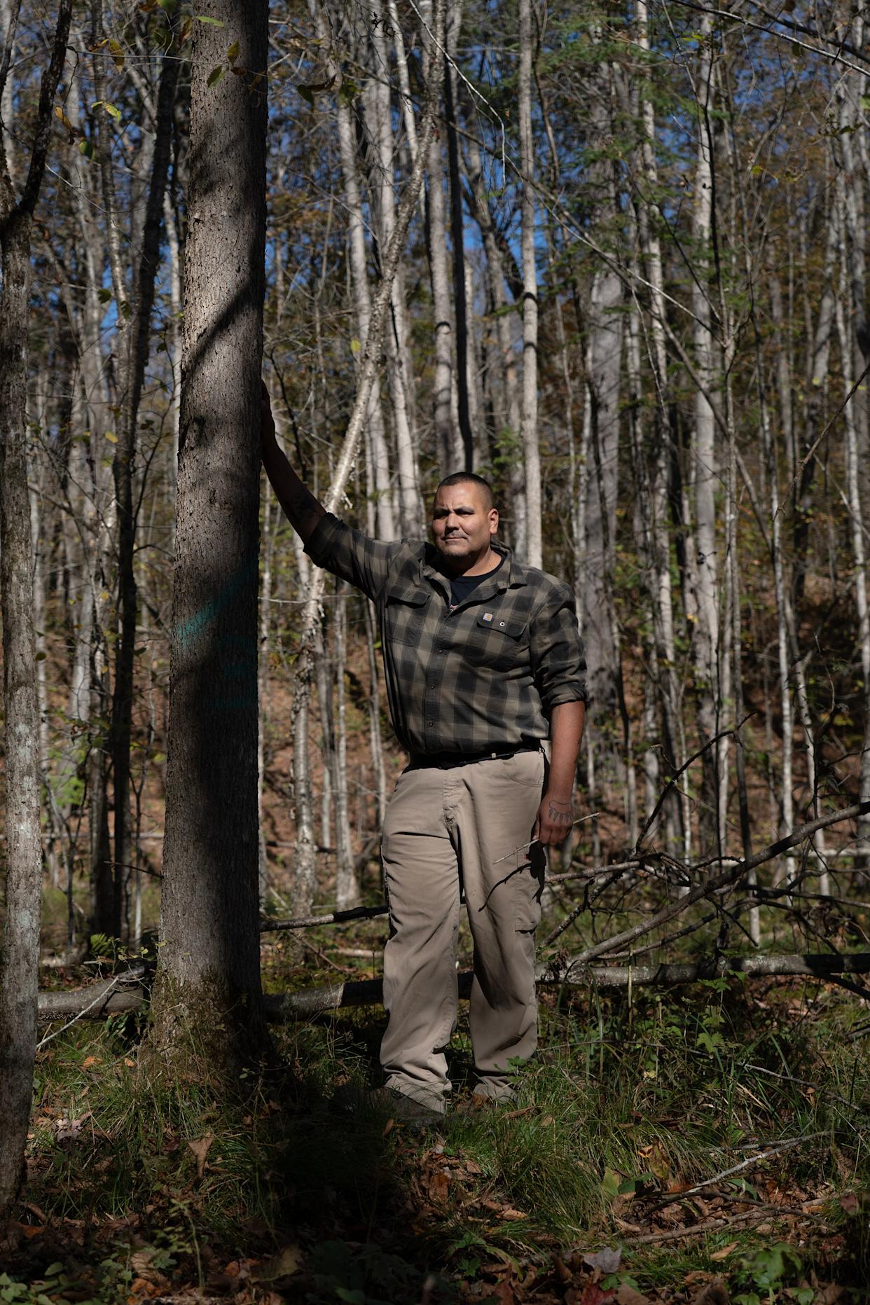 Forester Leon Fowler points out some of the 20 trees that were injected with insecticide in a black ash tree swamp on the Menominee reservation in Neopit, Wisconsin, on the afternoon of Oct. 9, 2025. Black ash trees are an important part of the water filtration system on the reservation.
