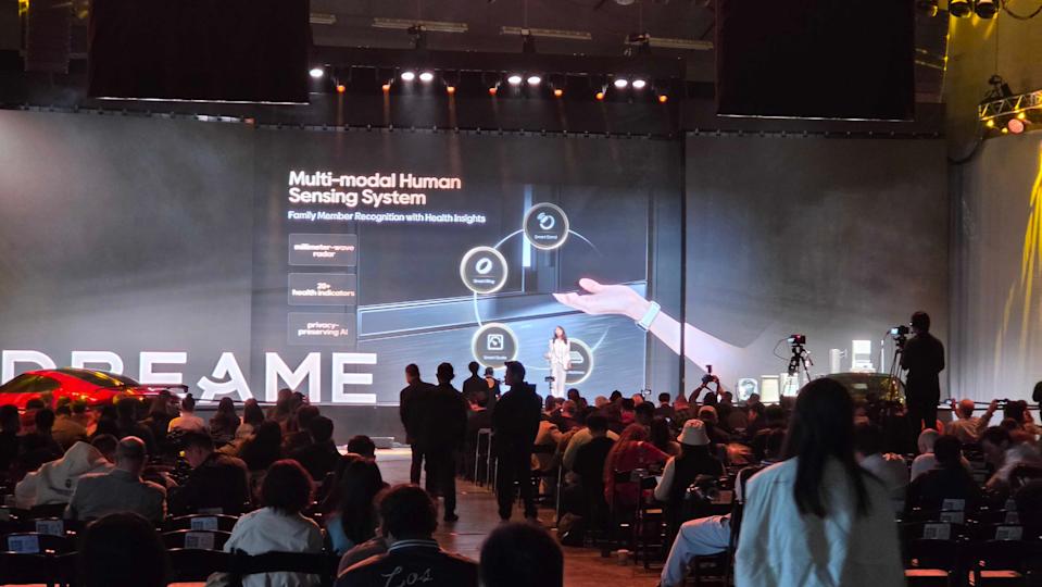 A Dreame spokesperson on stage, presenting the Dreame Fridge to a crowd of people