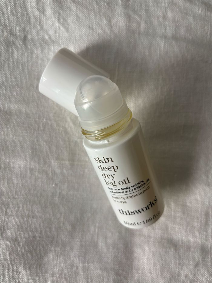Deputy beauty editor Grace Lindsay testing the This Works Skin Deep Dry Leg Oil Roller