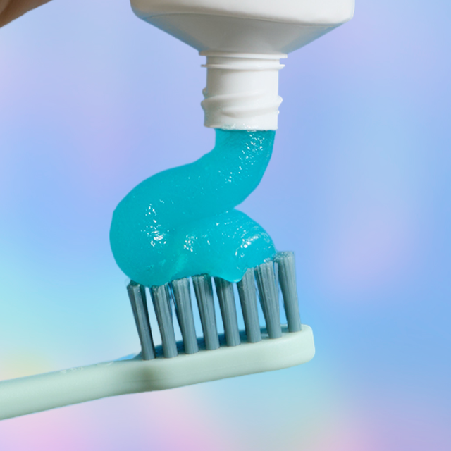 Toothbrush with blue toothpaste being applied.