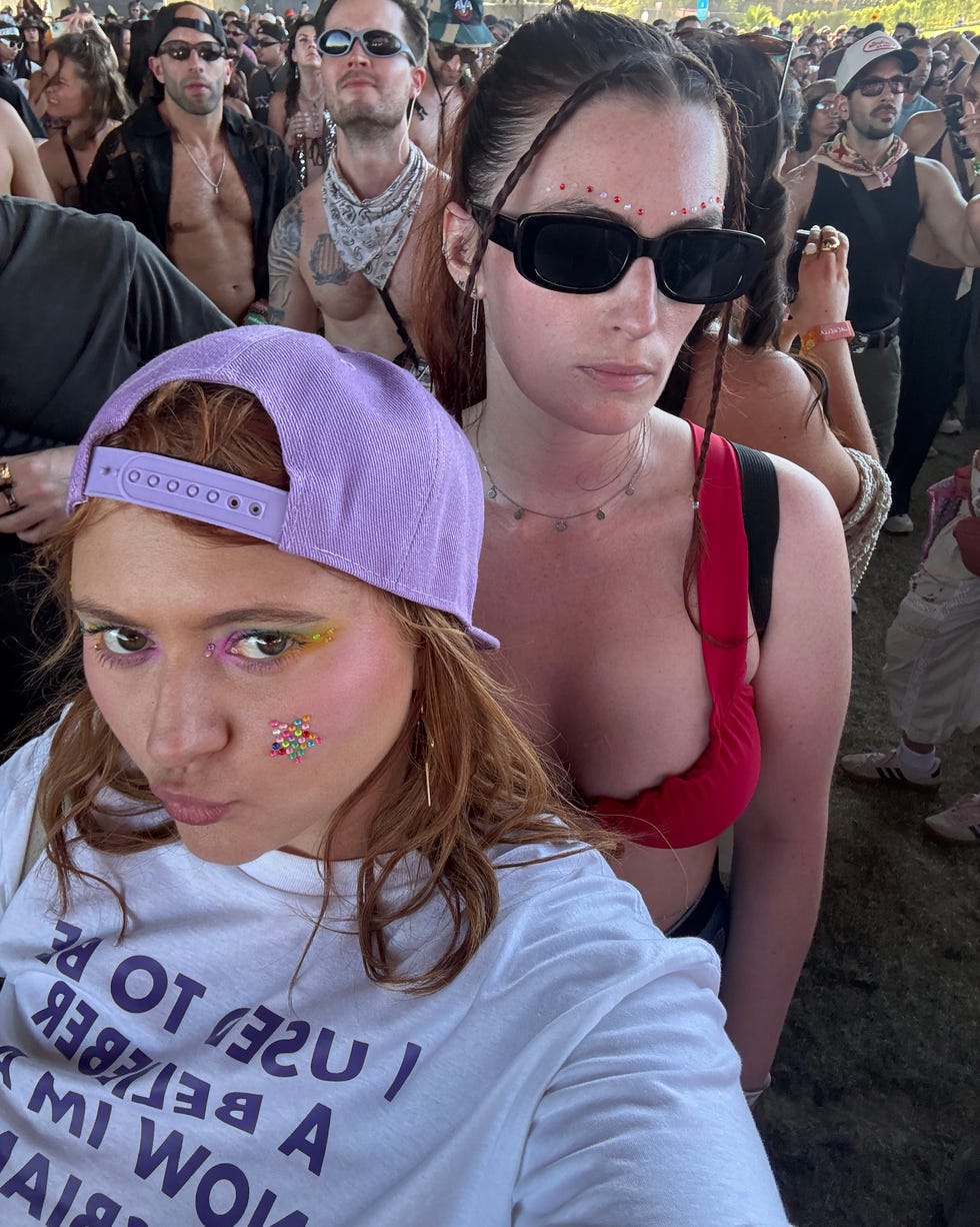 Selfie at a crowded event with blurred faces in the background.