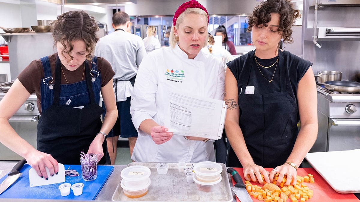 Chef Heather Nace, RD, LDN, teaching students at the Goldring Center for Culinary Medicine. Students seen chopping onions and sweet potatoes.
