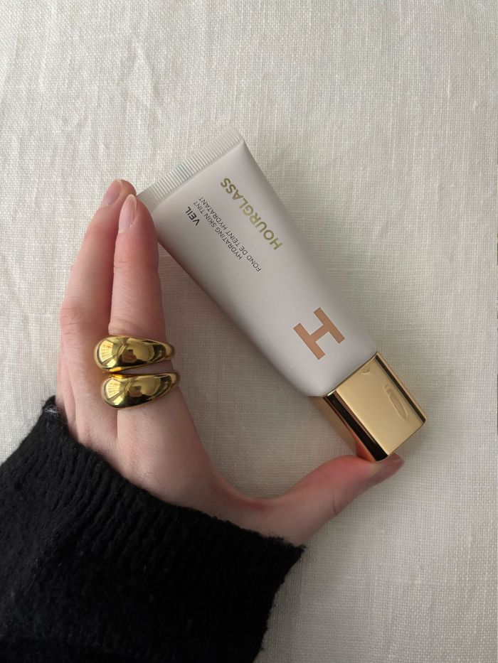 Deputy beauty editor Grace Lindsay holding the Hourglass Veil Hydrating Skin Tint