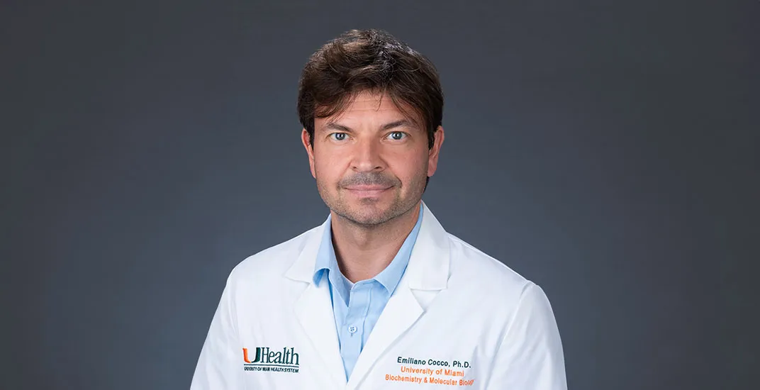 Dr. Emiliano Cocco, in light blue shirt and white medical coat