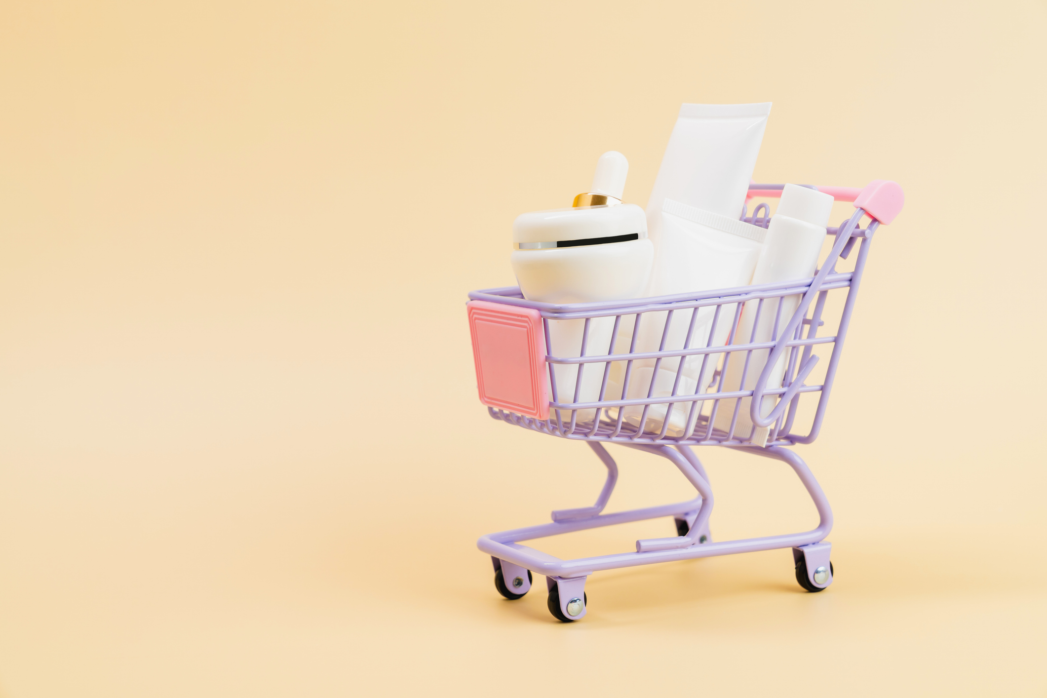Cosmetic bottles with blank labels in a shopping cart