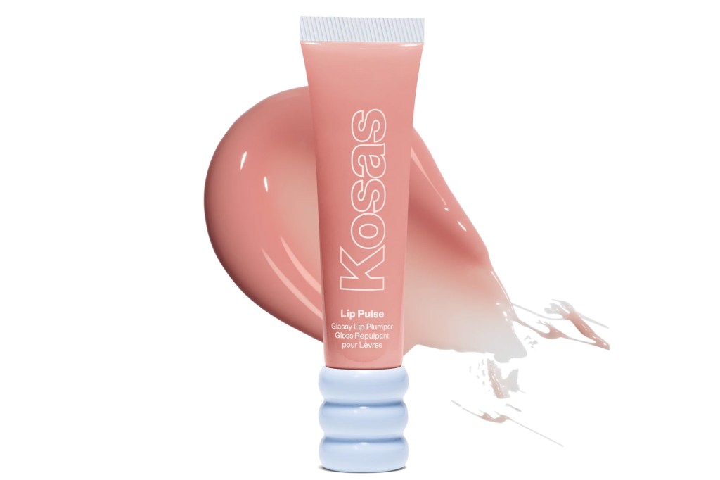 Kosas Lip Pulse Glossy Lip Plumper in a light pink tube with a light blue textured bottom, against a smear of light pink lip gloss.
