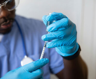 Health worker prepares vaccine injection. Photo by Nappy on Unsplash