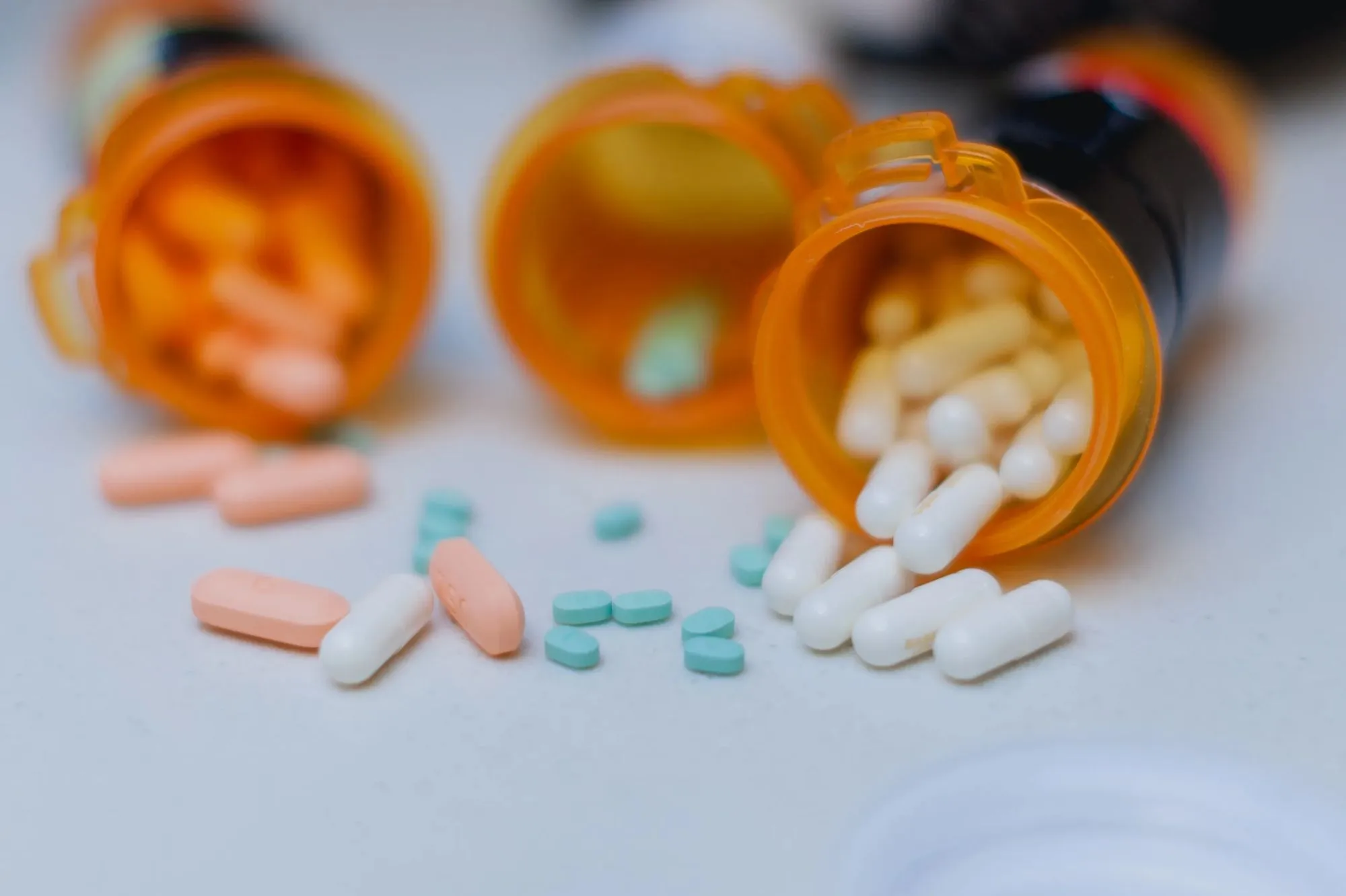 An image collage containing 1 images, Image 1 shows ADHD medication spilled from pill bottles