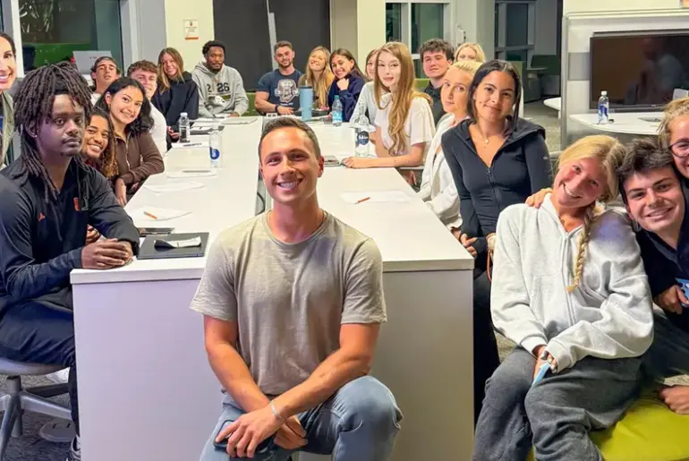 Rhonda Trust and her nutrition and communication class poses for a group photo with guest speaker Hunter Stoler, a certified health coach and content creator.