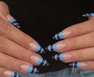 An image of blue and brown striped French tips.