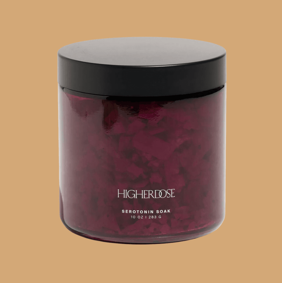 Purple jar of HigherDose Serotonin Soak with a black lid on a beige background.